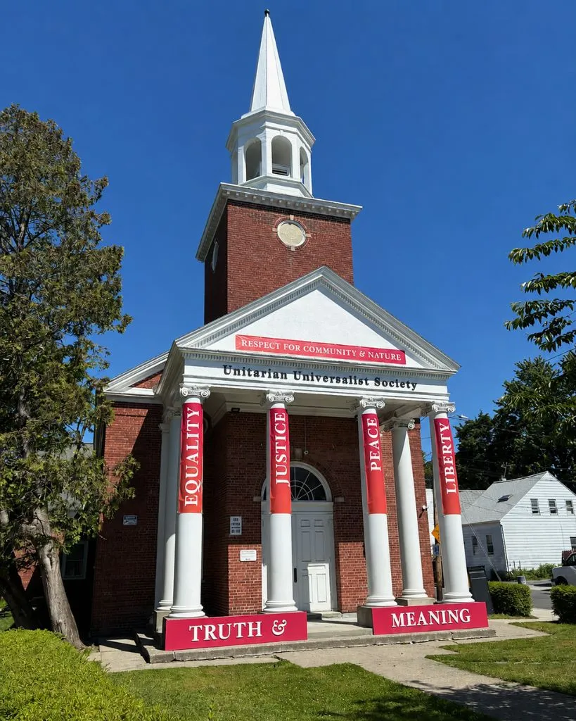 The Unitarian Universalist Society building with red pillar banners reading Equality, Justice, Peace, and Liberty