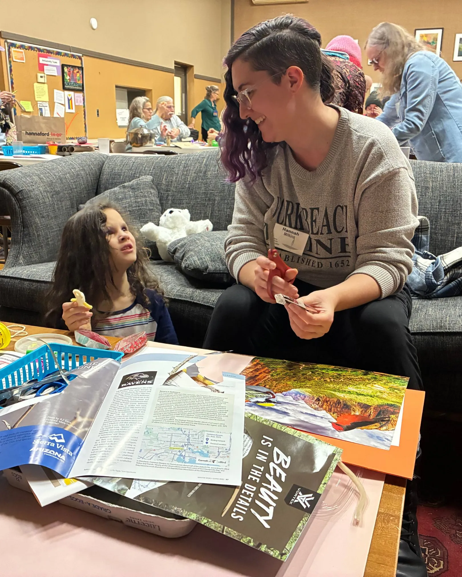 A young child and an adult reading a picture book together indoors