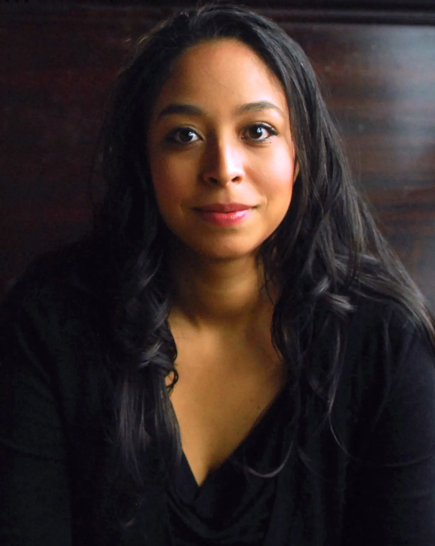 Portrait of Olga Martinez against a dark background