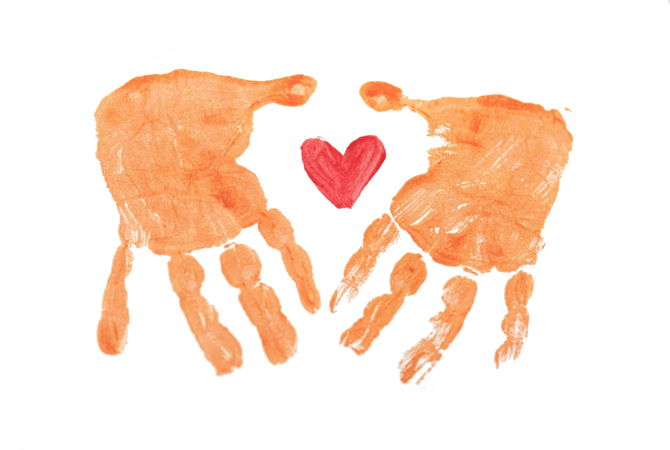 A child's orange handprints on either side of a painted red heart