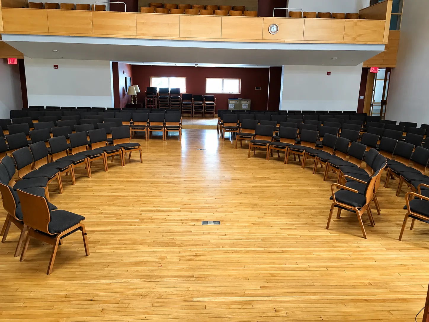 Chairs arranged in a large circle in a community hall