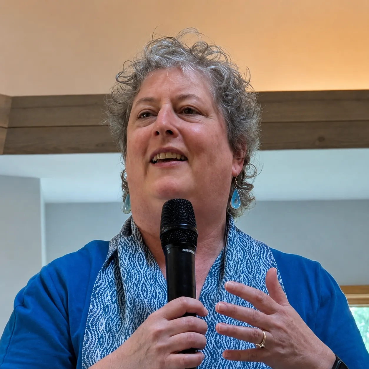 Sarah Richards speaking into a microphone